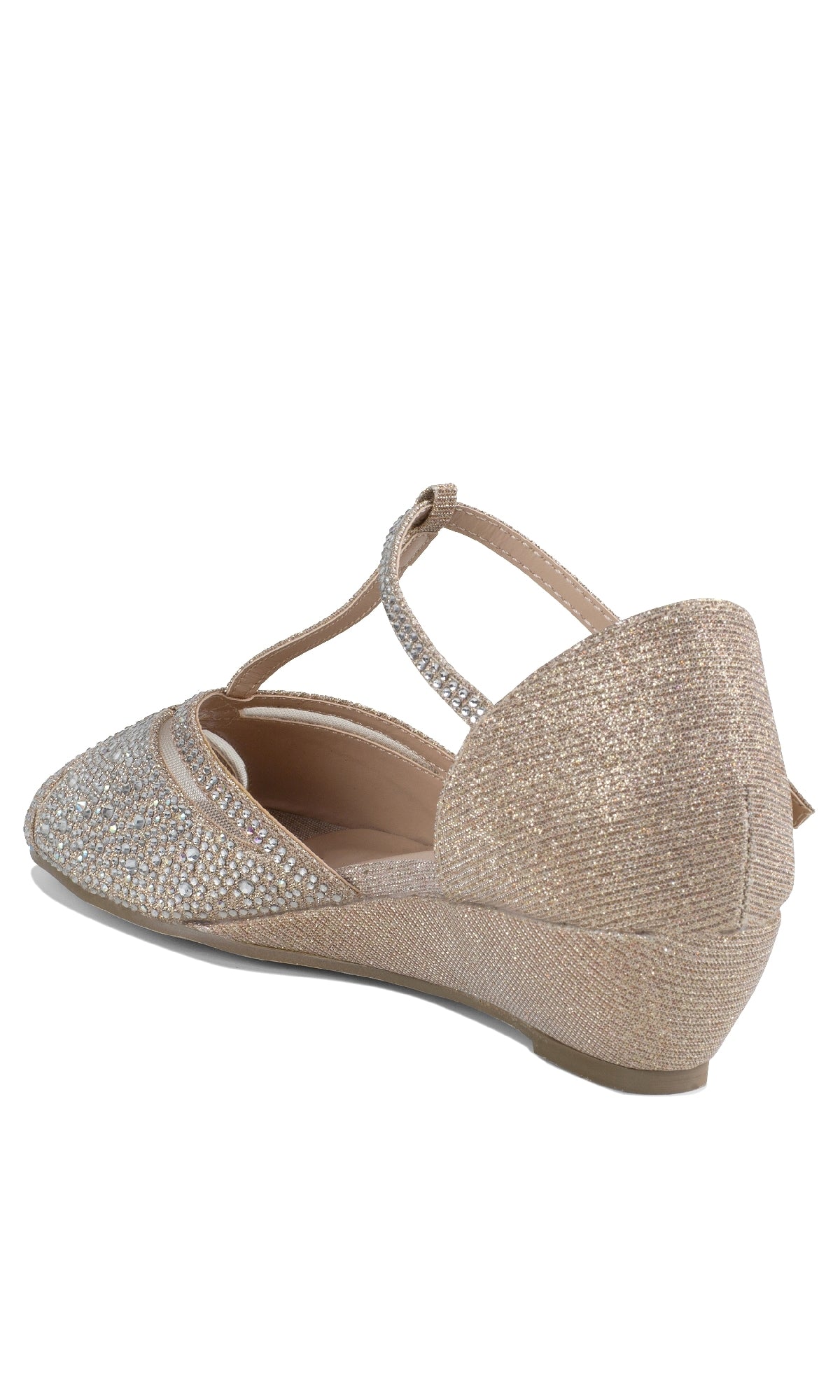 The Janelle Champagne Prom Shoes by Paradox London (P2209) feature a light gold shimmer, rhinestone accents, open-toe design, and low wedge heels. Shown is a single women's shoe from the rear side angle.